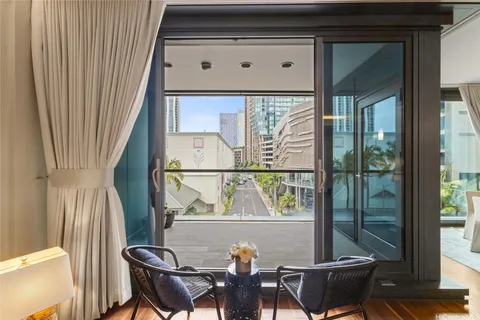 a view of a chairs and table in the balcony