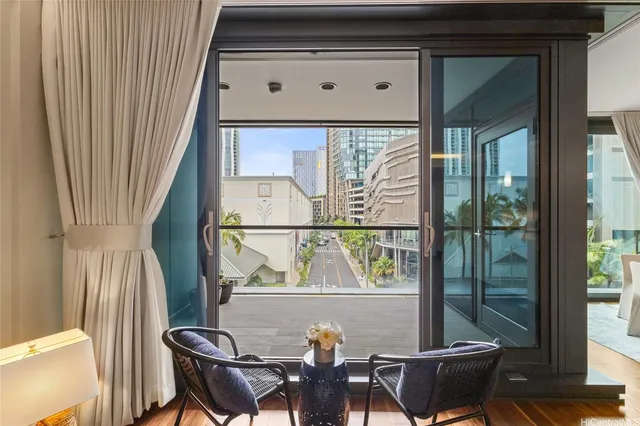 a view of a chairs and table in the balcony