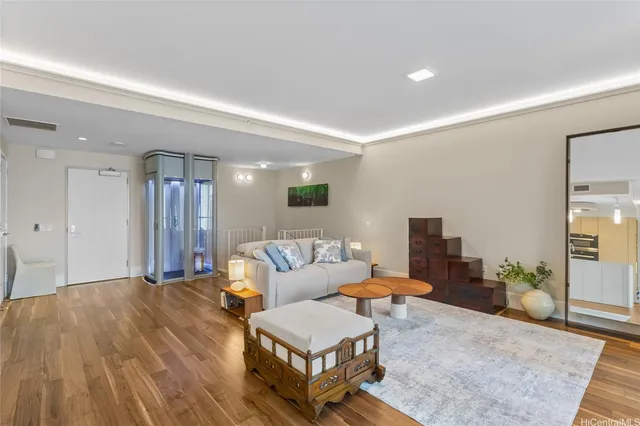 a living room with furniture and a wooden floor
