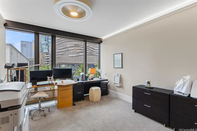 a room with a desk and a flat screen tv