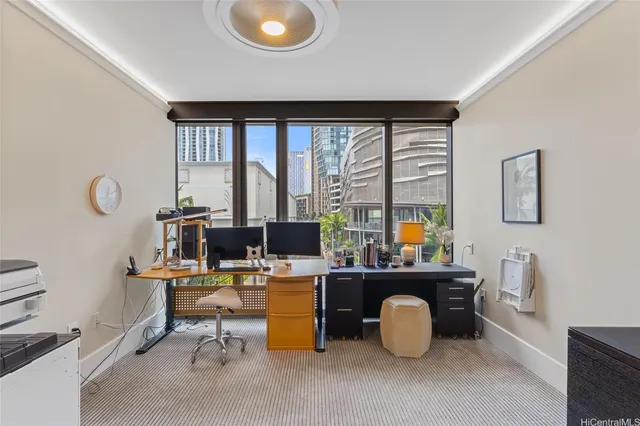a view of a workspace with furniture and a window