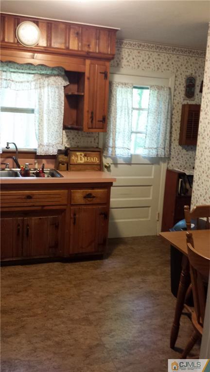 72 Spring Hill Road Old Bridge, NJ 07747 - Photo 3 of 4 a kitchen with stainless steel appliances granite countertop a stove a sink and a microwave
