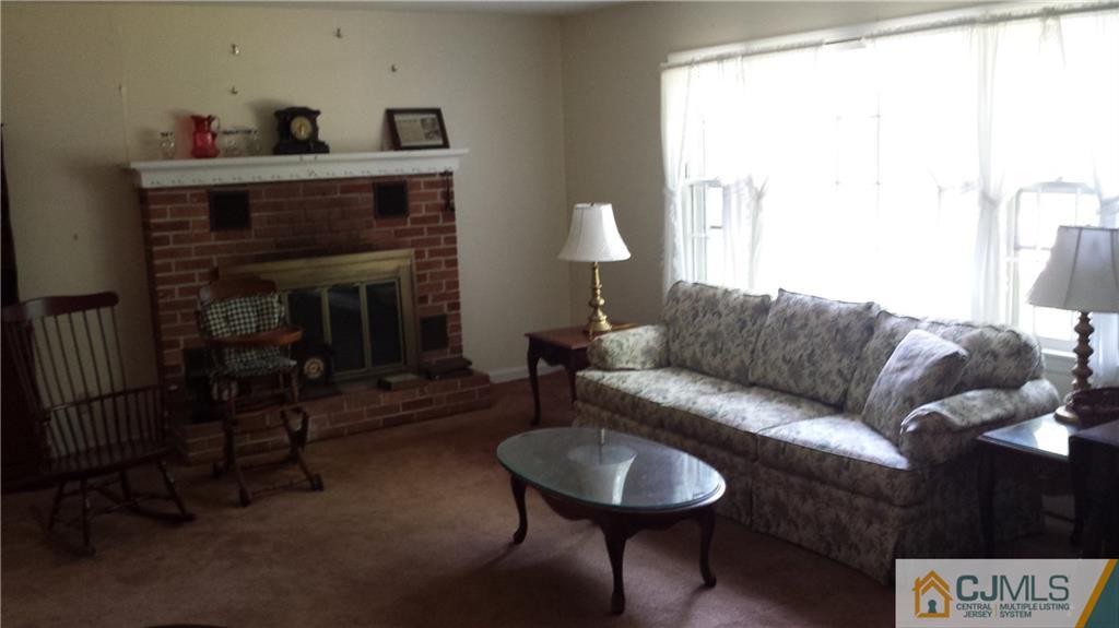 72 Spring Hill Road Old Bridge, NJ 07747 - Photo 4 of 4 a living room with furniture and a fireplace