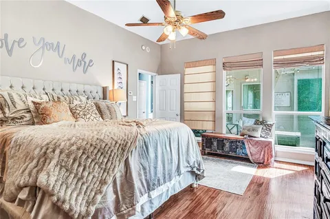 a bedroom with a bed and glass window