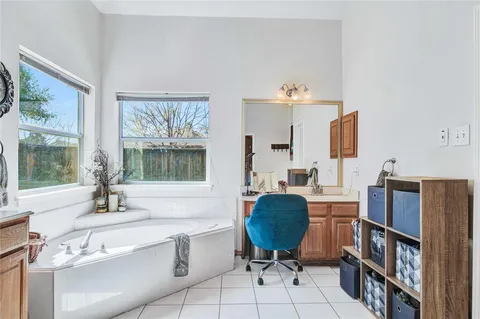 a bathroom with a sink a toilet and a window