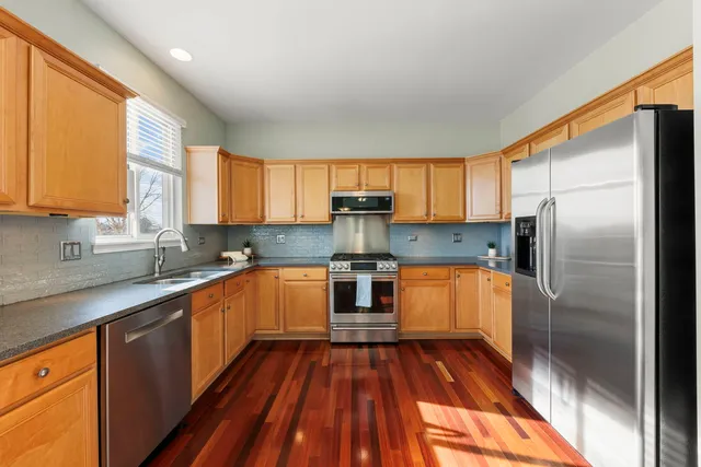 a kitchen with stainless steel appliances a refrigerator sink and cabinets