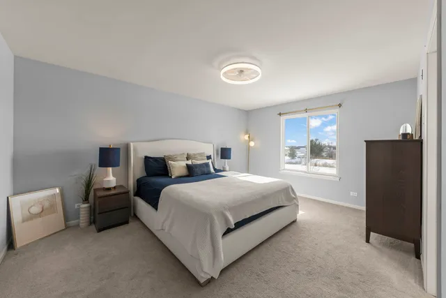 a bedroom with a bed and a large window