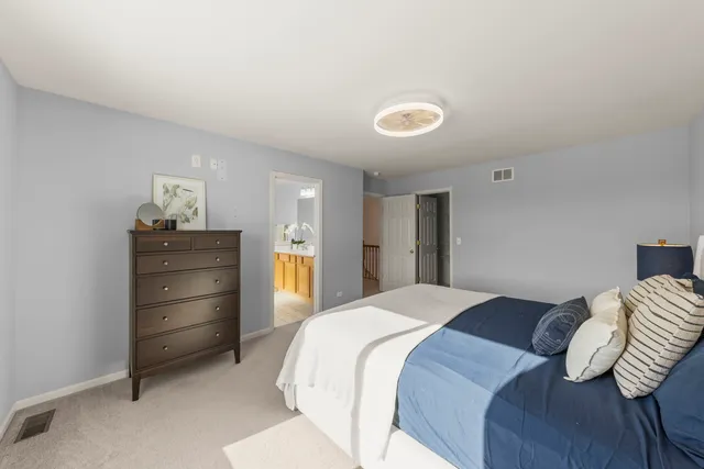 a bedroom with a bed and a dresser