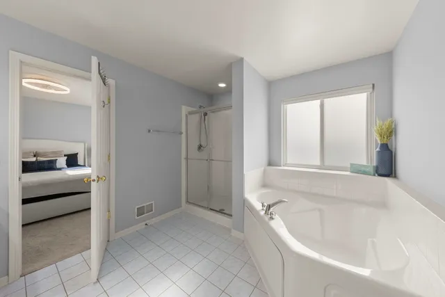 a bathroom with a bathtub and a shower