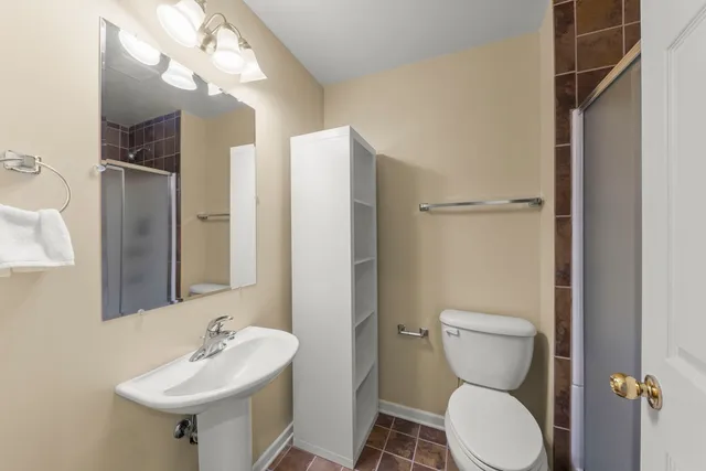 a bathroom with a sink toilet and shower