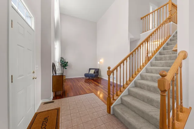 a view of entryway and hall with wooden floor