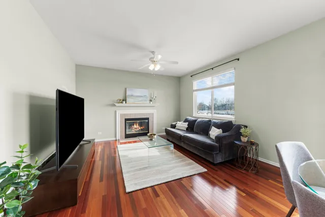 a living room with furniture a fireplace and a flat screen tv