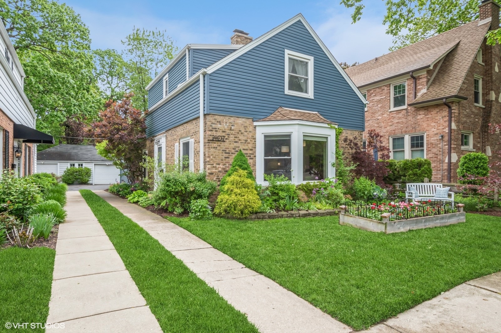 2107 Ewing Avenue Evanston, IL 60201 - Photo 1 of 36 a front view of a house with a garden and plants