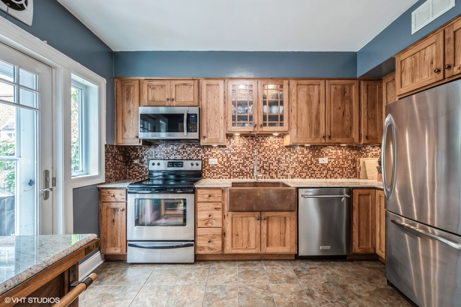 2107 Ewing Avenue Evanston, IL 60201 - Photo 12 of 36 a kitchen with stainless steel appliances granite countertop a stove a sink and a refrigerator