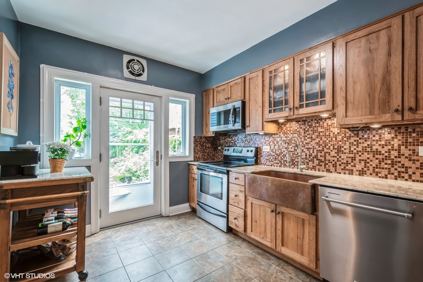 2107 Ewing Avenue Evanston, IL 60201 - Photo 13 of 36 a kitchen with stainless steel appliances granite countertop a stove a sink and a microwave