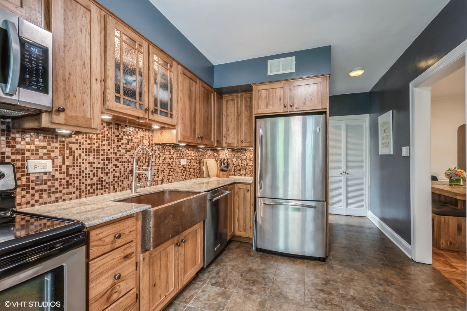 2107 Ewing Avenue Evanston, IL 60201 - Photo 14 of 36 a kitchen with stainless steel appliances granite countertop a refrigerator a stove and a sink