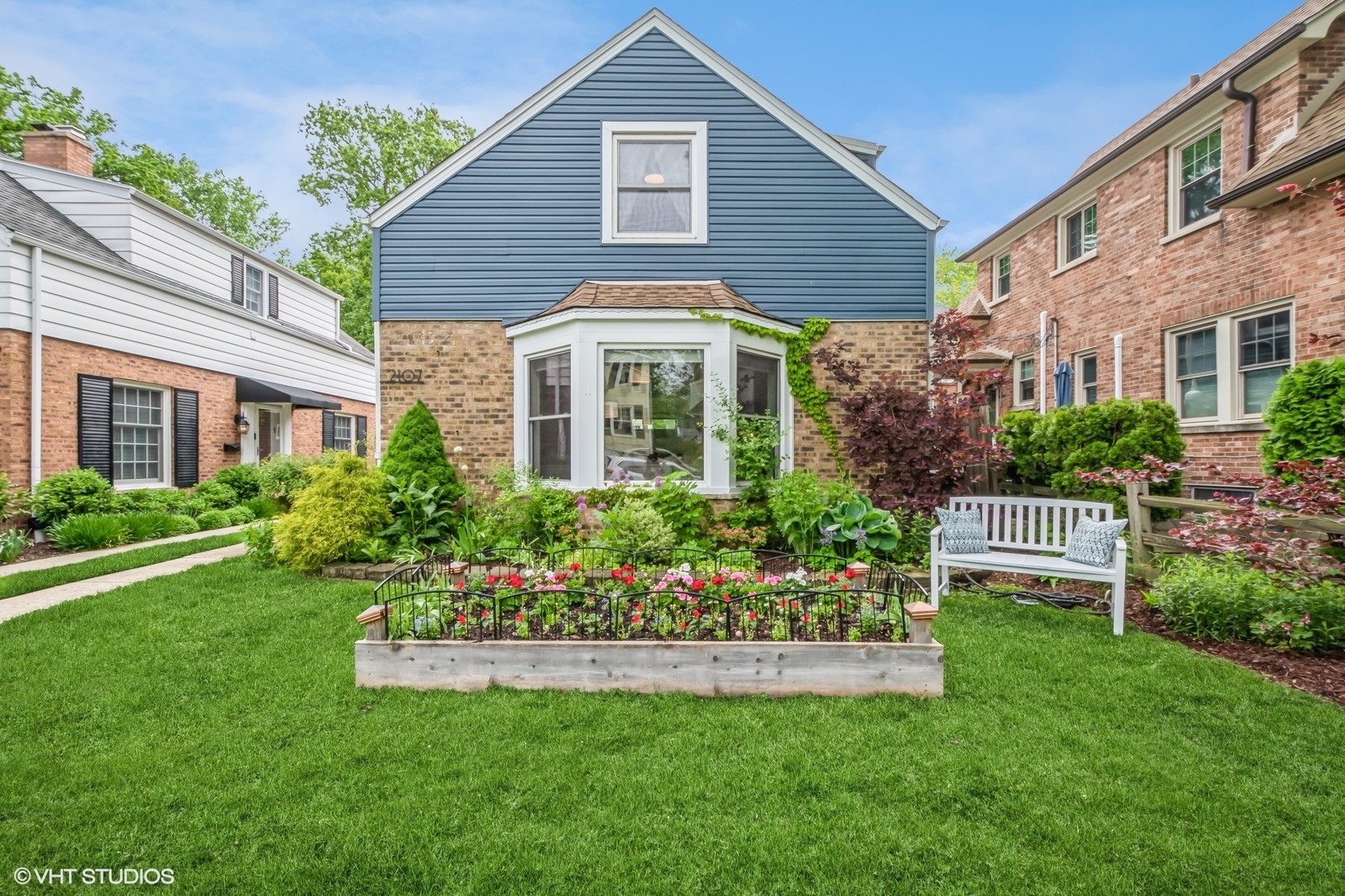 2107 Ewing Avenue Evanston, IL 60201 - Photo 2 of 36 a front view of a house with a garden and plants