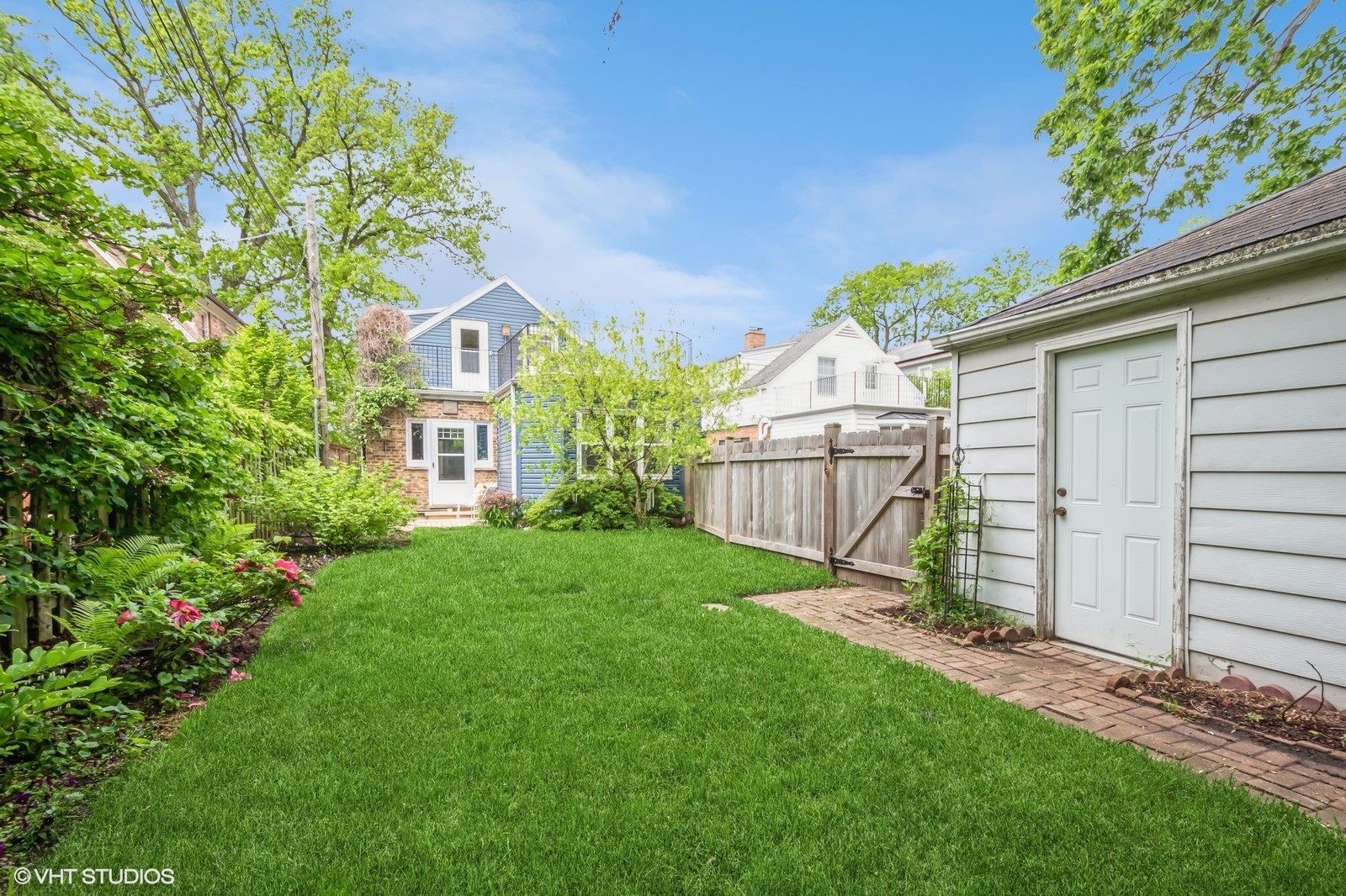 2107 Ewing Avenue Evanston, IL 60201 - Photo 29 of 36 a front view of a house with a garden and yard