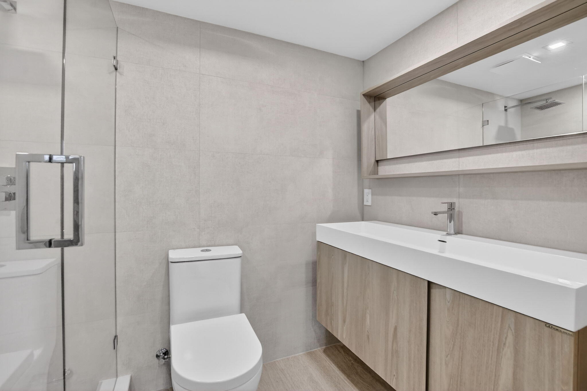 7835 Lakeside Boulevard, Unit 946 Boca Raton, FL 33434 - Photo 15 of 20 a bathroom with a toilet sink and mirror