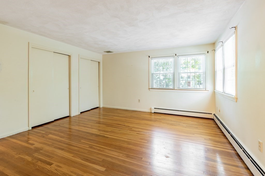 35 Williams Road Sharon, MA 02067 - Photo 11 of 25 a view of an empty room with wooden floor and a window
