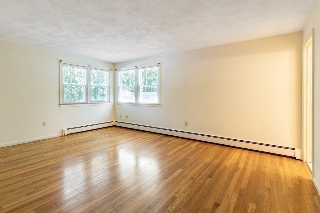 35 Williams Road Sharon, MA 02067 - Photo 12 of 25 an empty room with wooden floor and windows