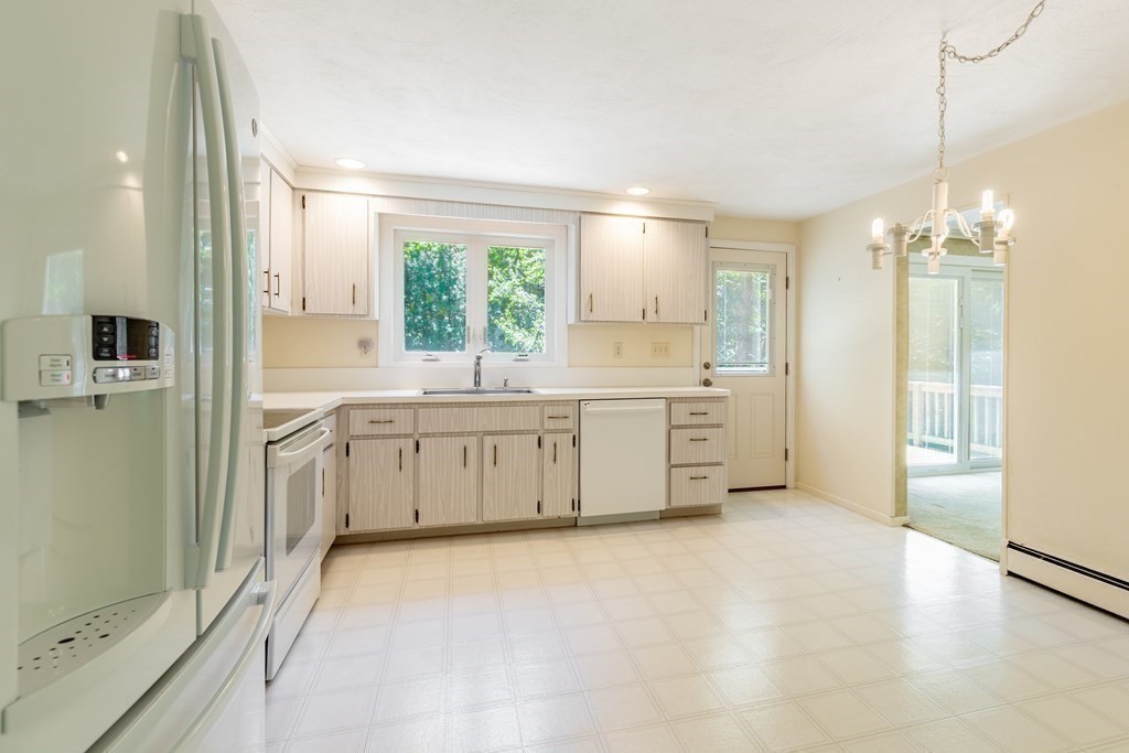 35 Williams Road Sharon, MA 02067 - Photo 8 of 25 a view of a kitchen with a sink and dishwasher a refrigerator with white cabinets