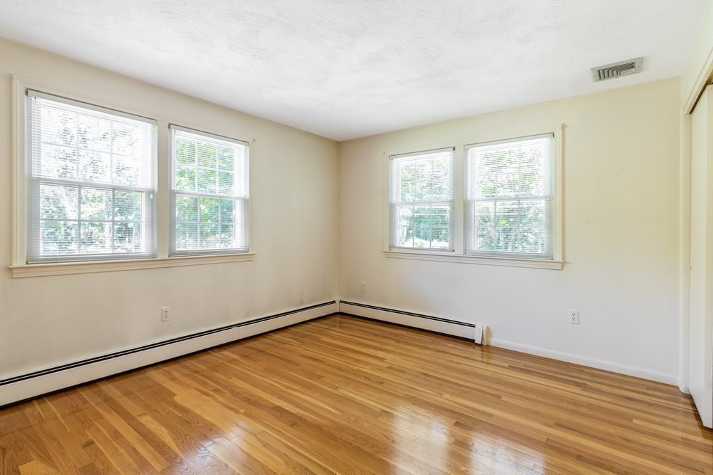35 Williams Road Sharon, MA 02067 - Photo 10 of 25 a view of an empty room with wooden floor and a window