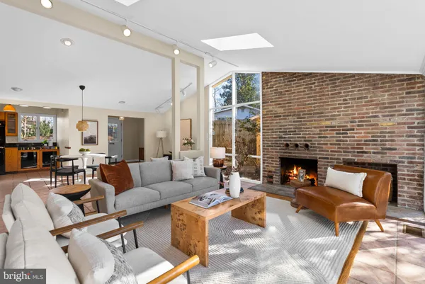 a living room with fireplace furniture and a fireplace