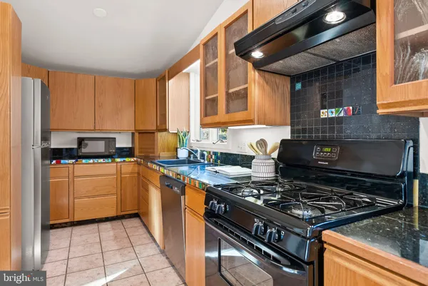 a kitchen with a stove a sink and a refrigerator