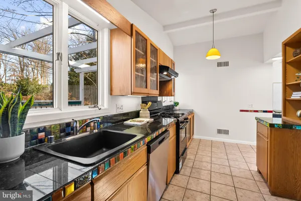 a kitchen that has a sink and a stove