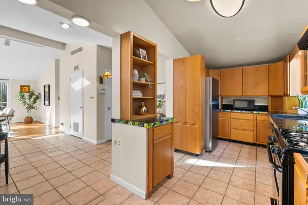 a kitchen with a refrigerator a stove top oven a sink and cabinets