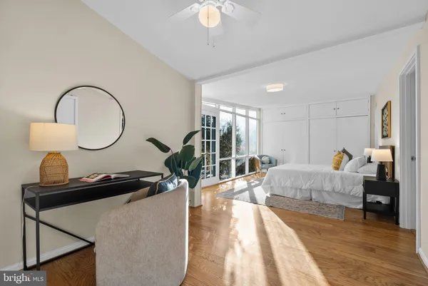 a living room with furniture a chandelier and a wooden floor