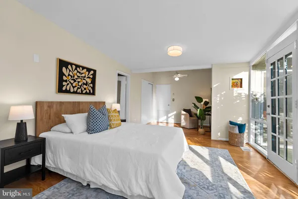 a bedroom with a bed and a large mirror