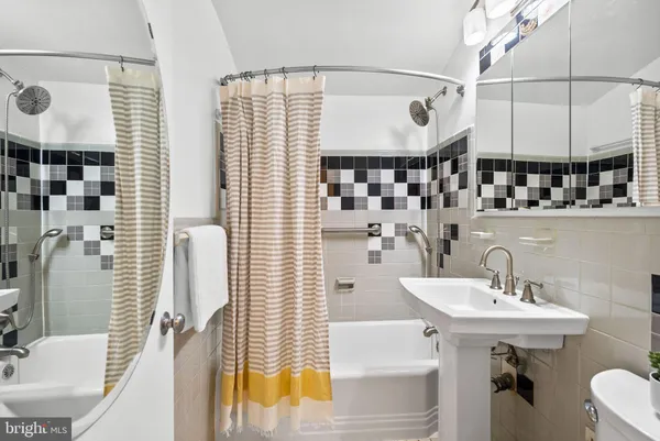 a bathroom with a sink a mirror and shower
