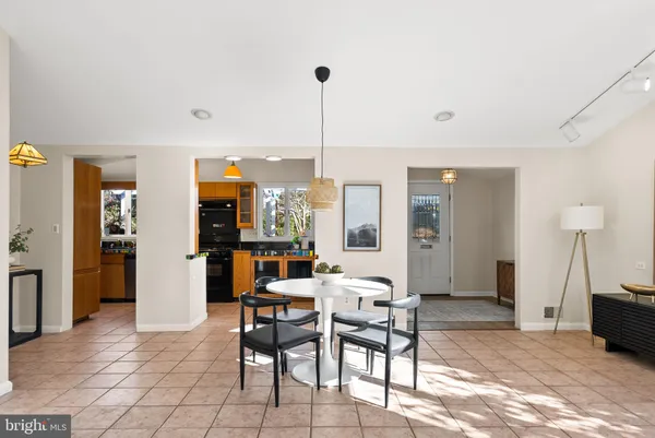 a dining room with furniture and wooden floor