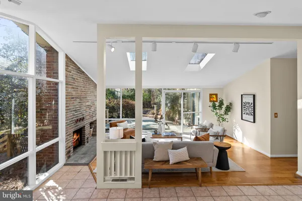 a living room with fireplace furniture and a large window