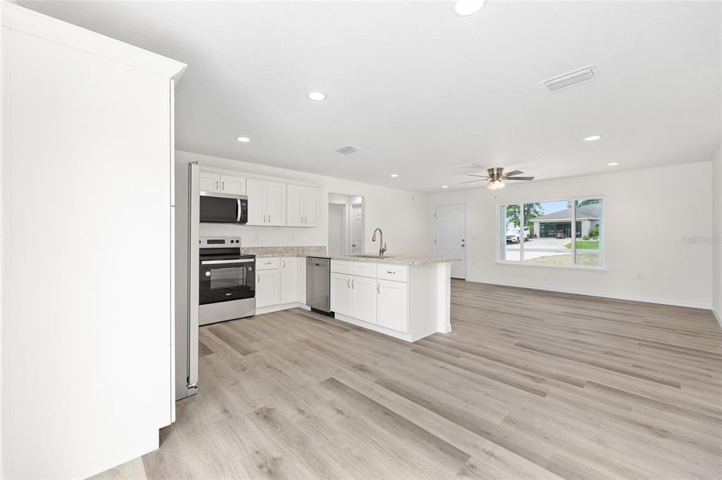 13019 Northeast 7th Loop Silver Springs, FL 34488 - Photo 15 of 35 a view of kitchen with wooden floor