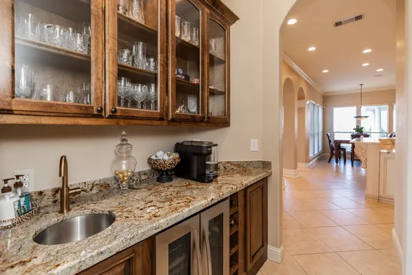a bathroom with a granite countertop toilet sink and mirror