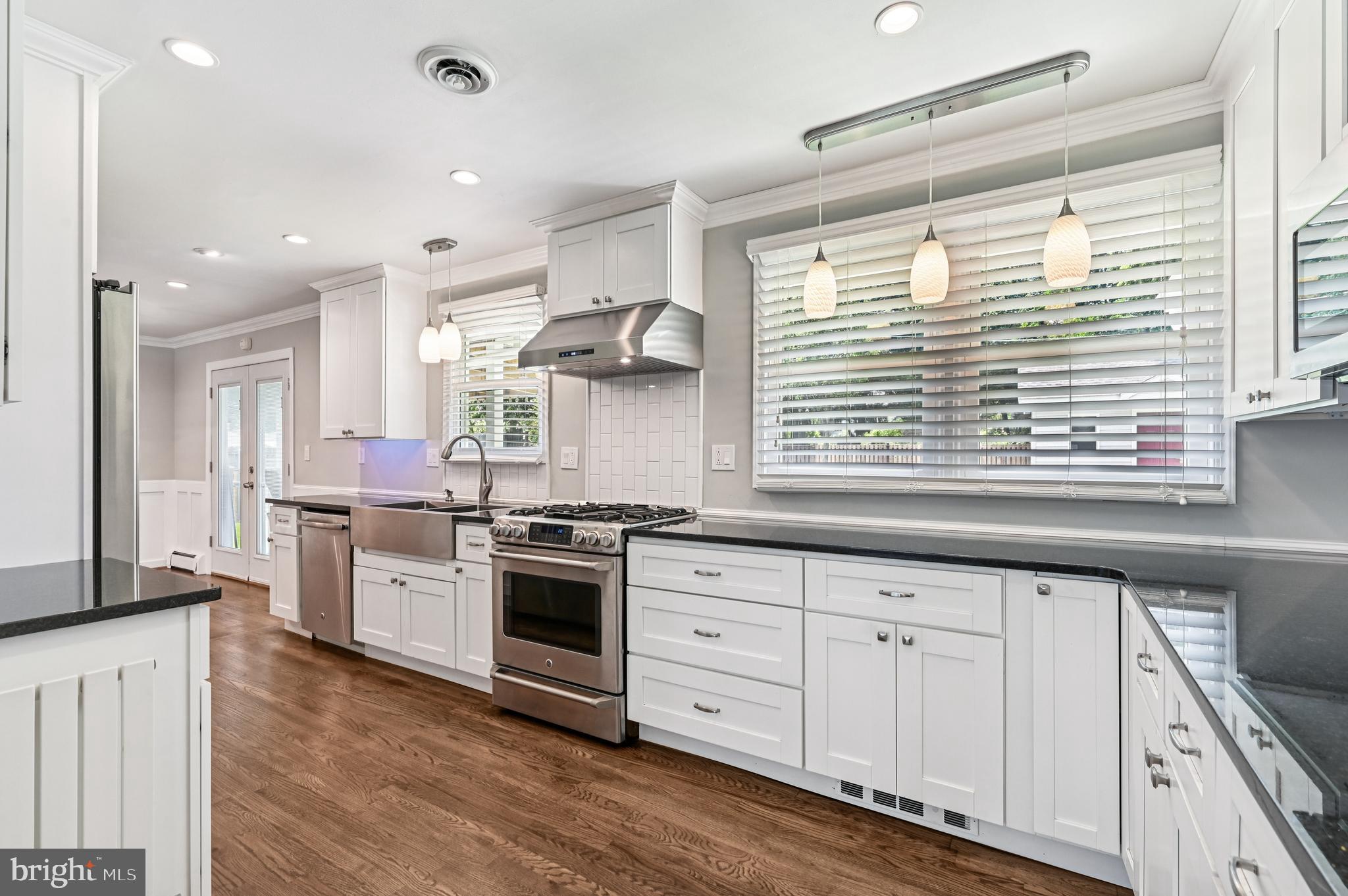 536 Maple Ridge Lane Odenton, MD 21113 - Photo 14 of 48 a kitchen with granite countertop a stove and a sink