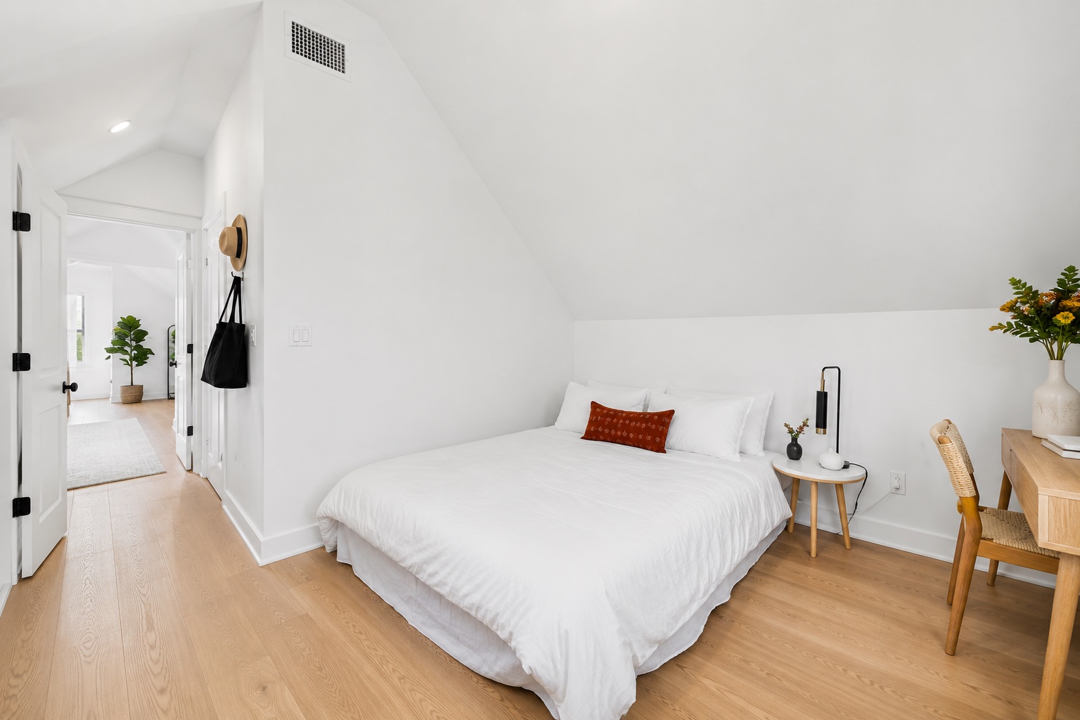 5007 Lott Avenue, Unit 1 Austin, TX 78721 - Photo 13 of 24 Slanted ceilings and light wood floors create a cozy and airy bedroom retreat.