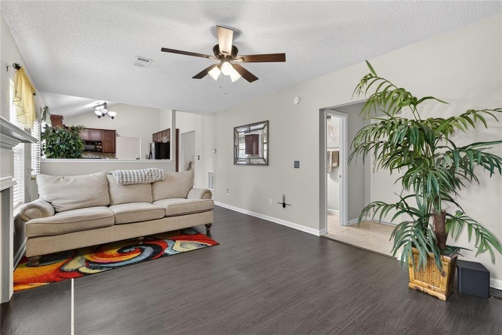 45 Windscape Drive Covington, GA 30016 - Photo 18 of 39 a living room with furniture and a potted plant