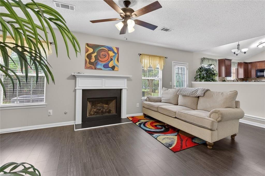 45 Windscape Drive Covington, GA 30016 - Photo 19 of 39 a living room with furniture and a fireplace