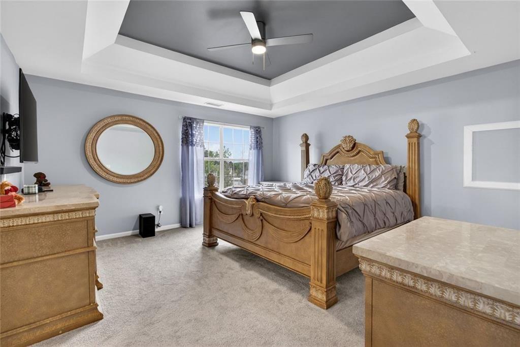 45 Windscape Drive Covington, GA 30016 - Photo 21 of 39 a bed room with a bed and a chandelier
