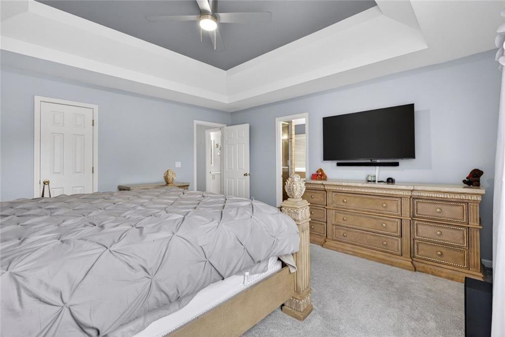 45 Windscape Drive Covington, GA 30016 - Photo 23 of 39 a bedroom with a bed and a flat screen tv