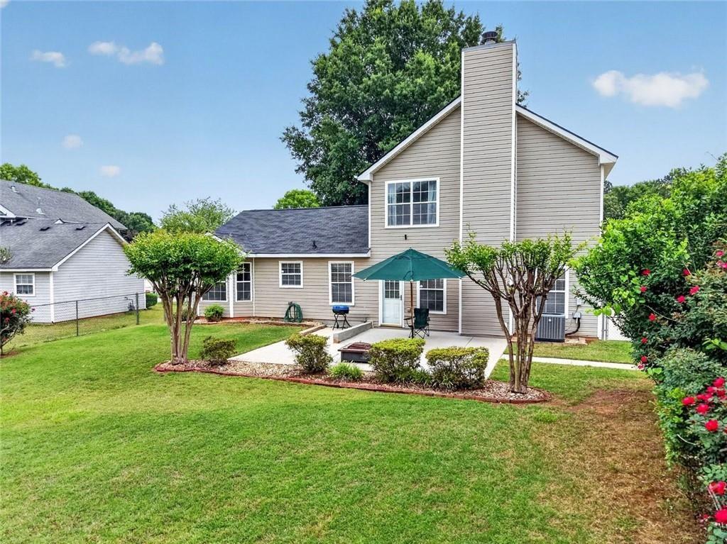 45 Windscape Drive Covington, GA 30016 - Photo 39 of 39 a front view of house with a garden and trees