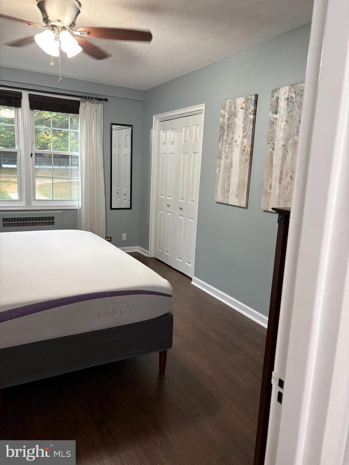 206 North George Mason Drive, Unit 1 Arlington, VA 22203 - Photo 19 of 28 a large bed sitting in a bedroom next to a window