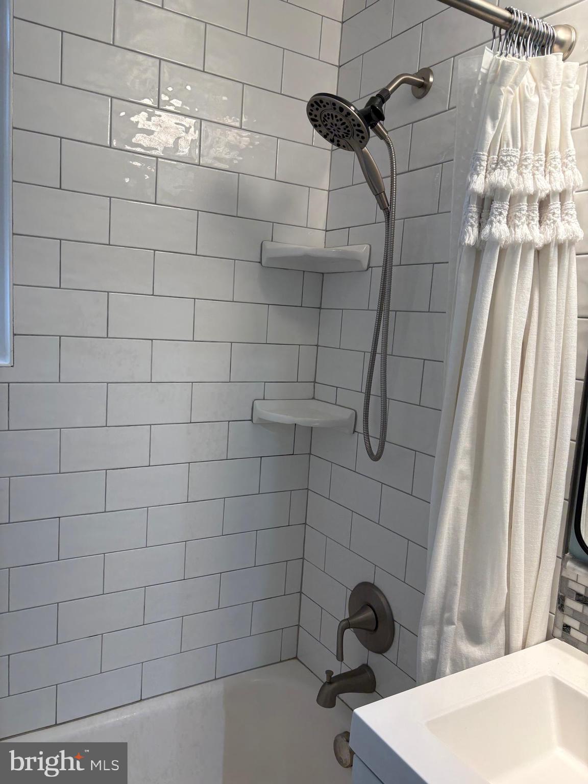 206 North George Mason Drive, Unit 1 Arlington, VA 22203 - Photo 25 of 28 a bathroom with a shower and a sink