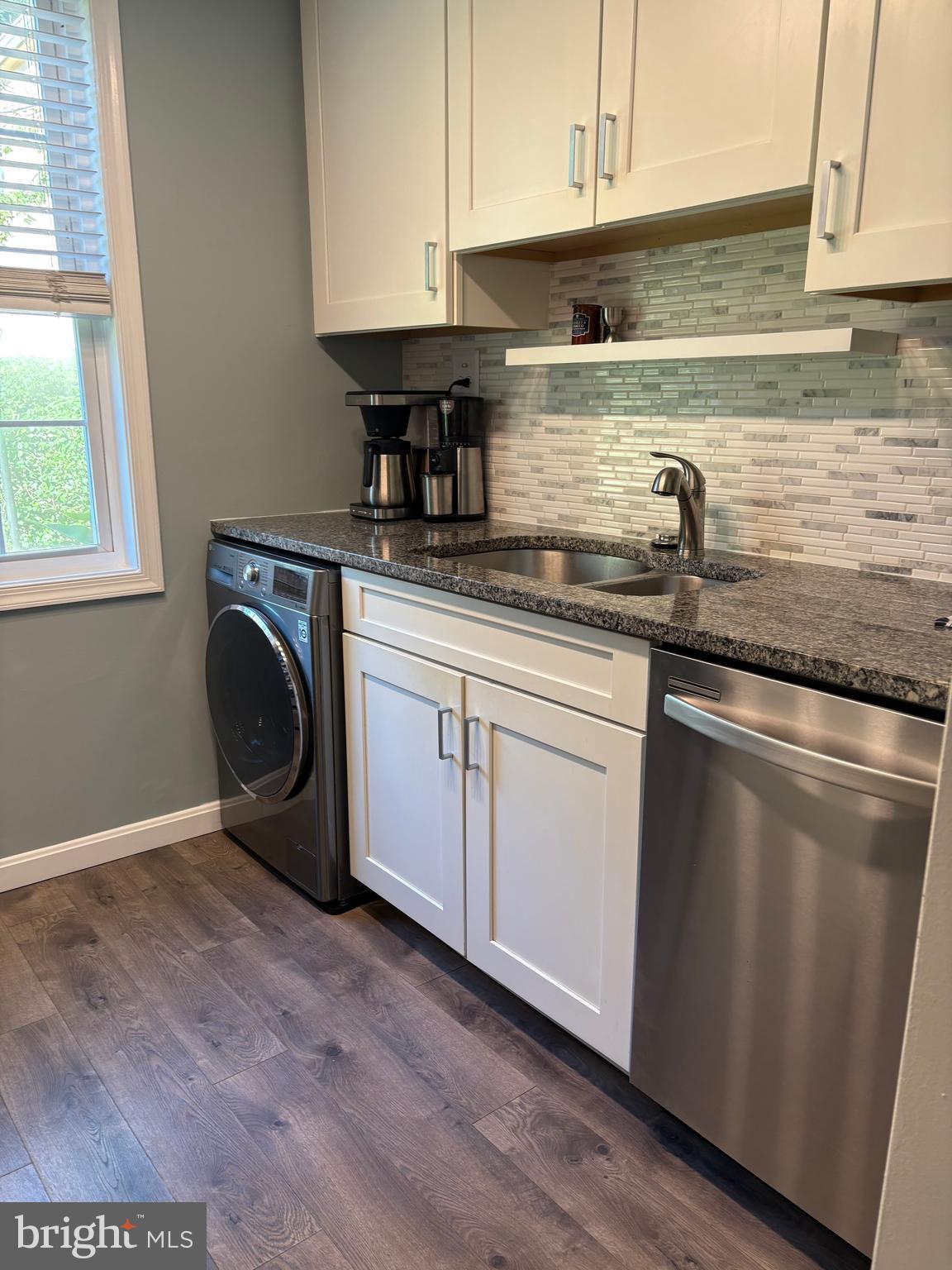 206 North George Mason Drive, Unit 1 Arlington, VA 22203 - Photo 10 of 28 a kitchen with granite countertop a sink a stove and cabinets