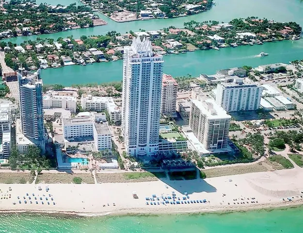 a view of a lake with a bench and city view