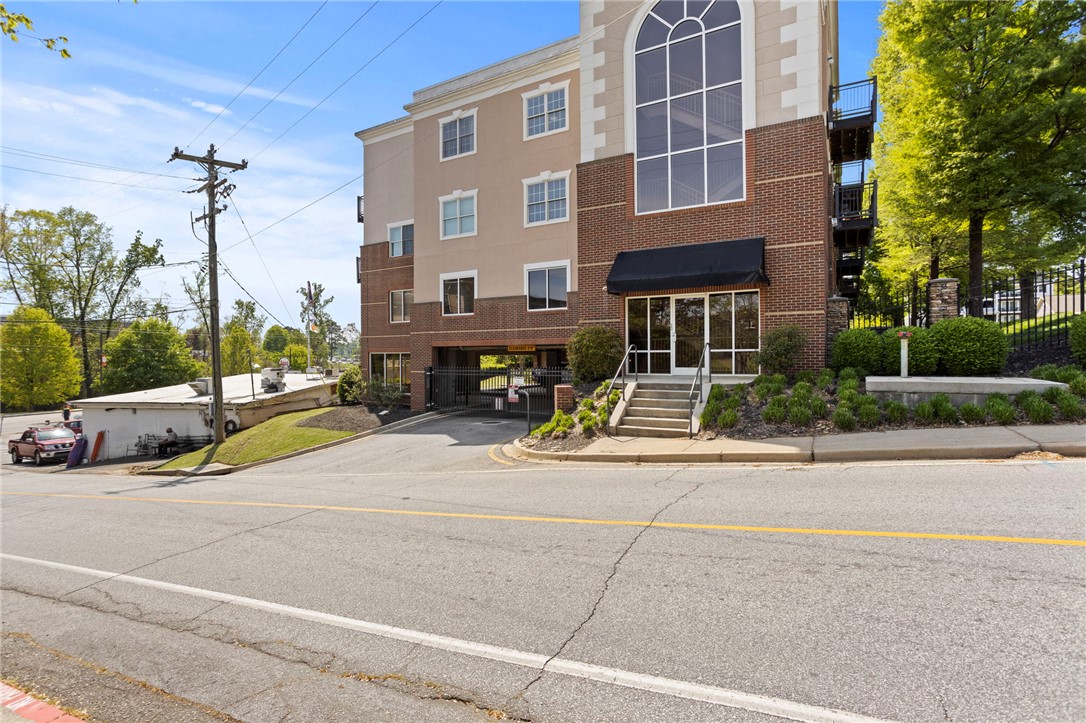 101 Oak Street, Unit 401 Clemson, SC 29631 - Photo 1 of 26 This structure presents a blend of brick and stucco finishes, featuring prominent arch windows.